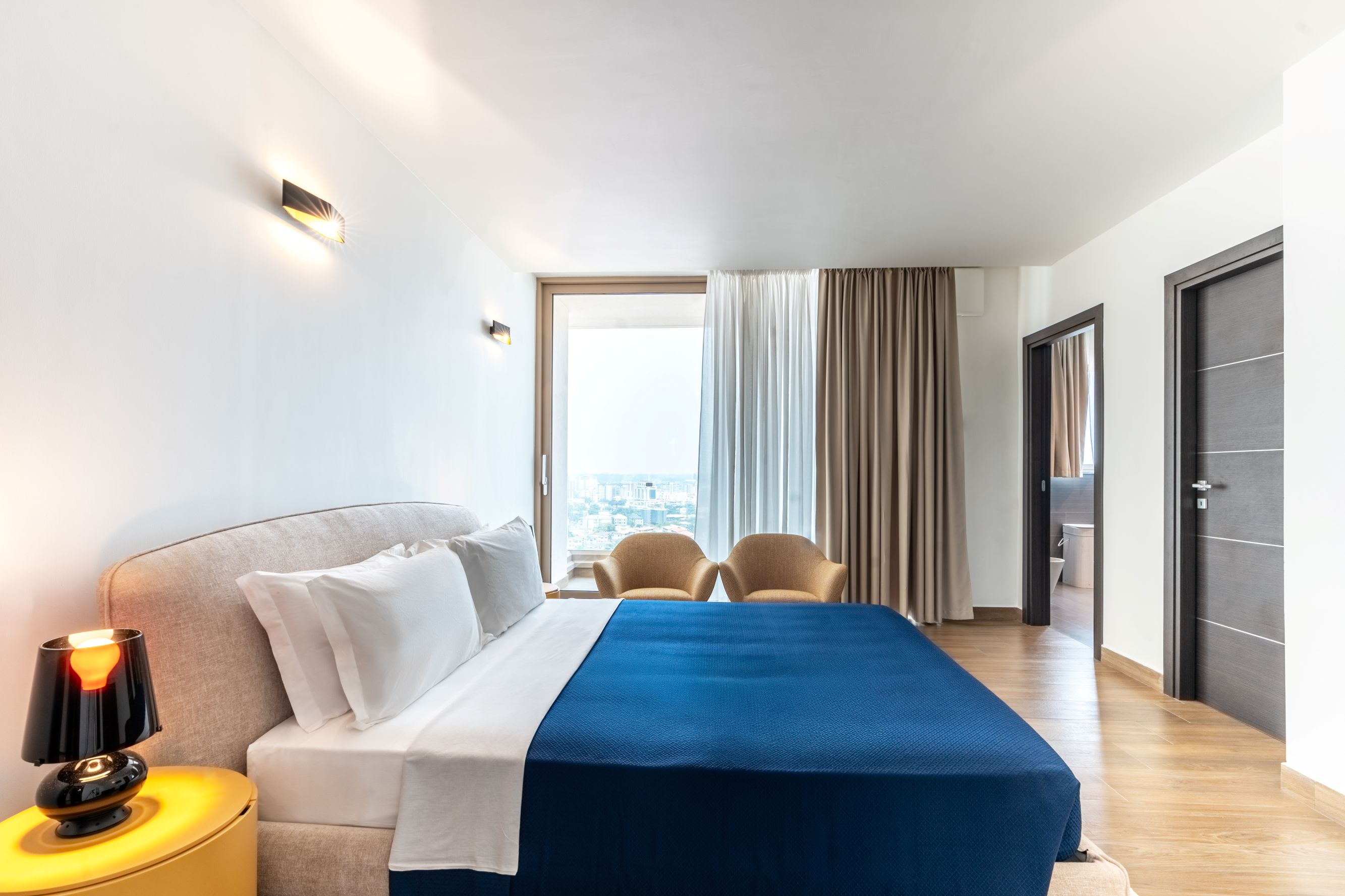 Luxury master bedroom with panoramic city views